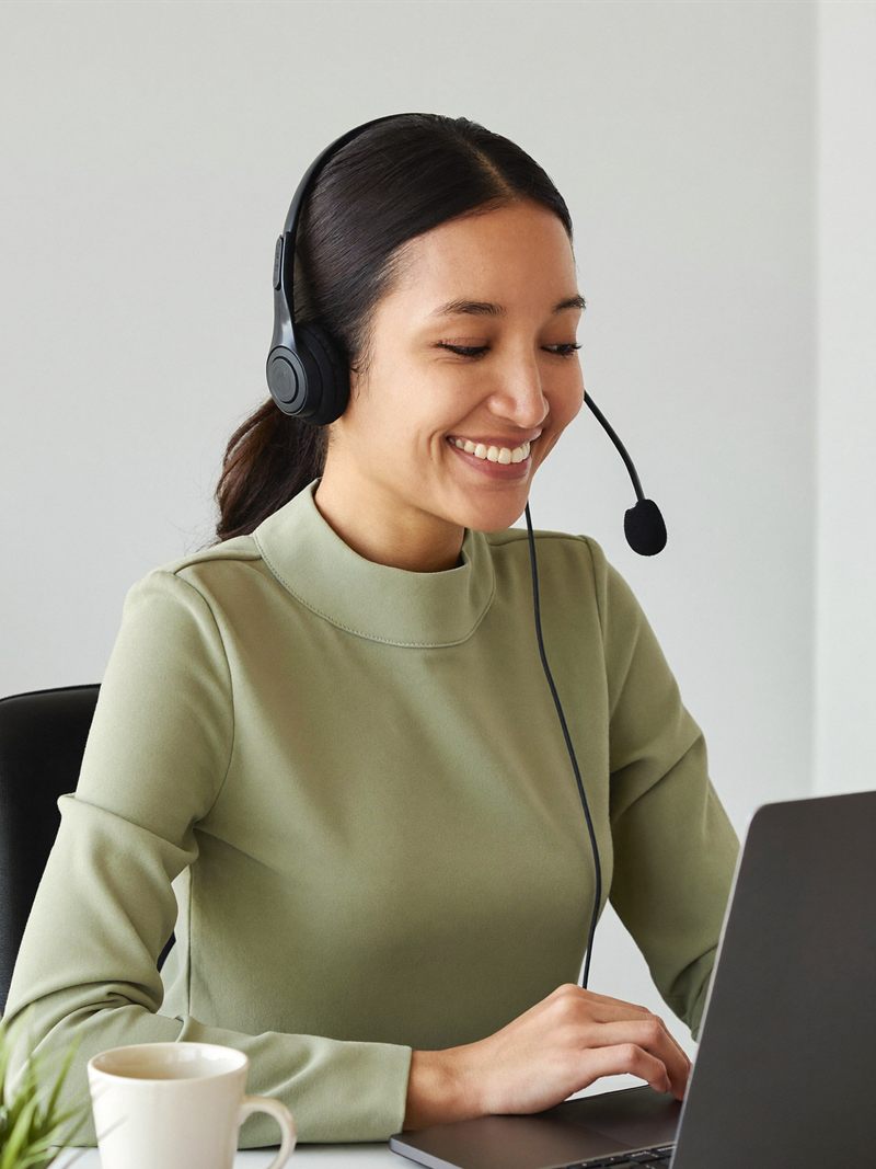 A healthcare VA on a headset call at a home desk